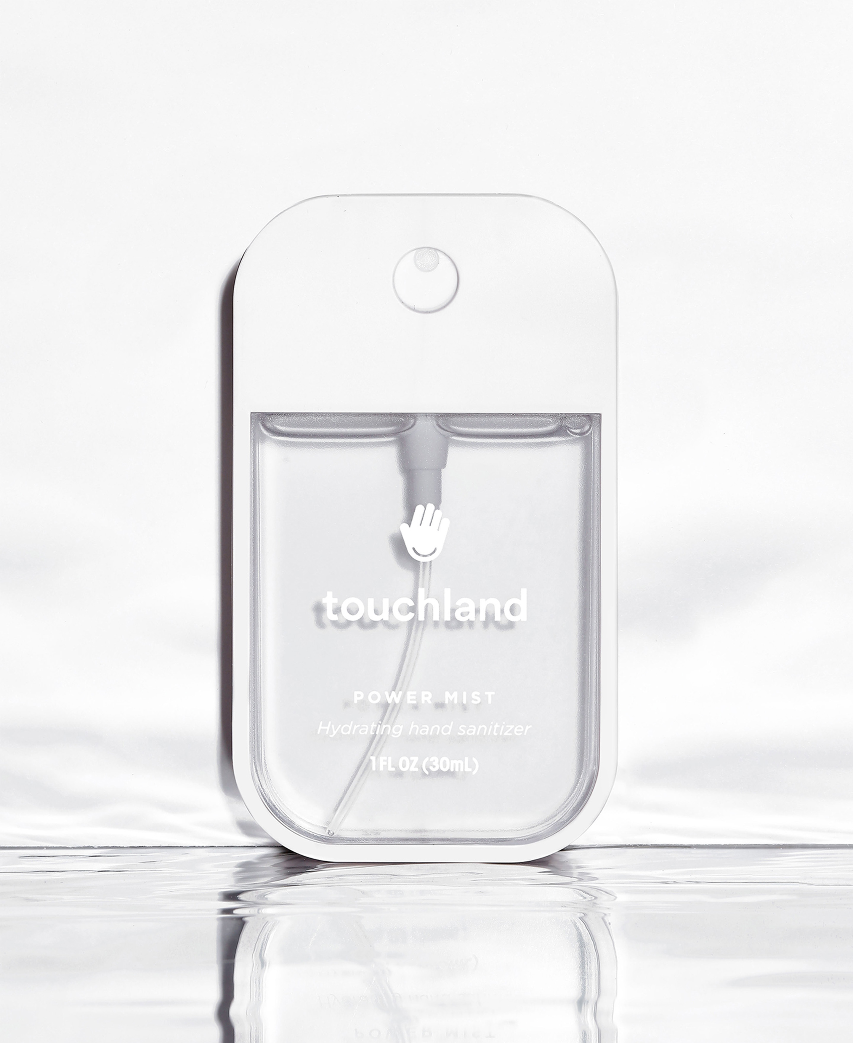 Frontal Power Mist hand sanitizer bottle pictures standing on a mirror effect base with water.