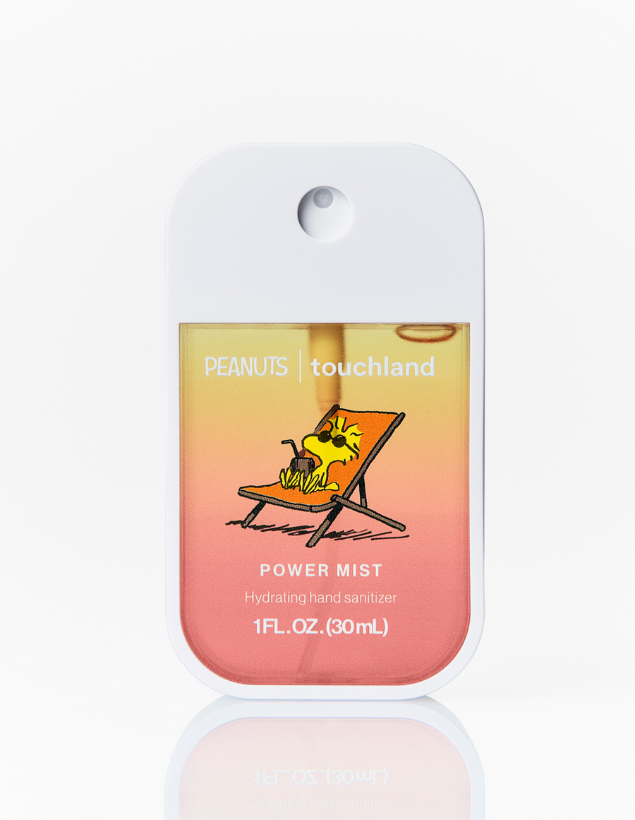 Hand sanitizer bottle with a gradient design featuring a dog on a beach chair, labeled 'PEANUTS touchland'.