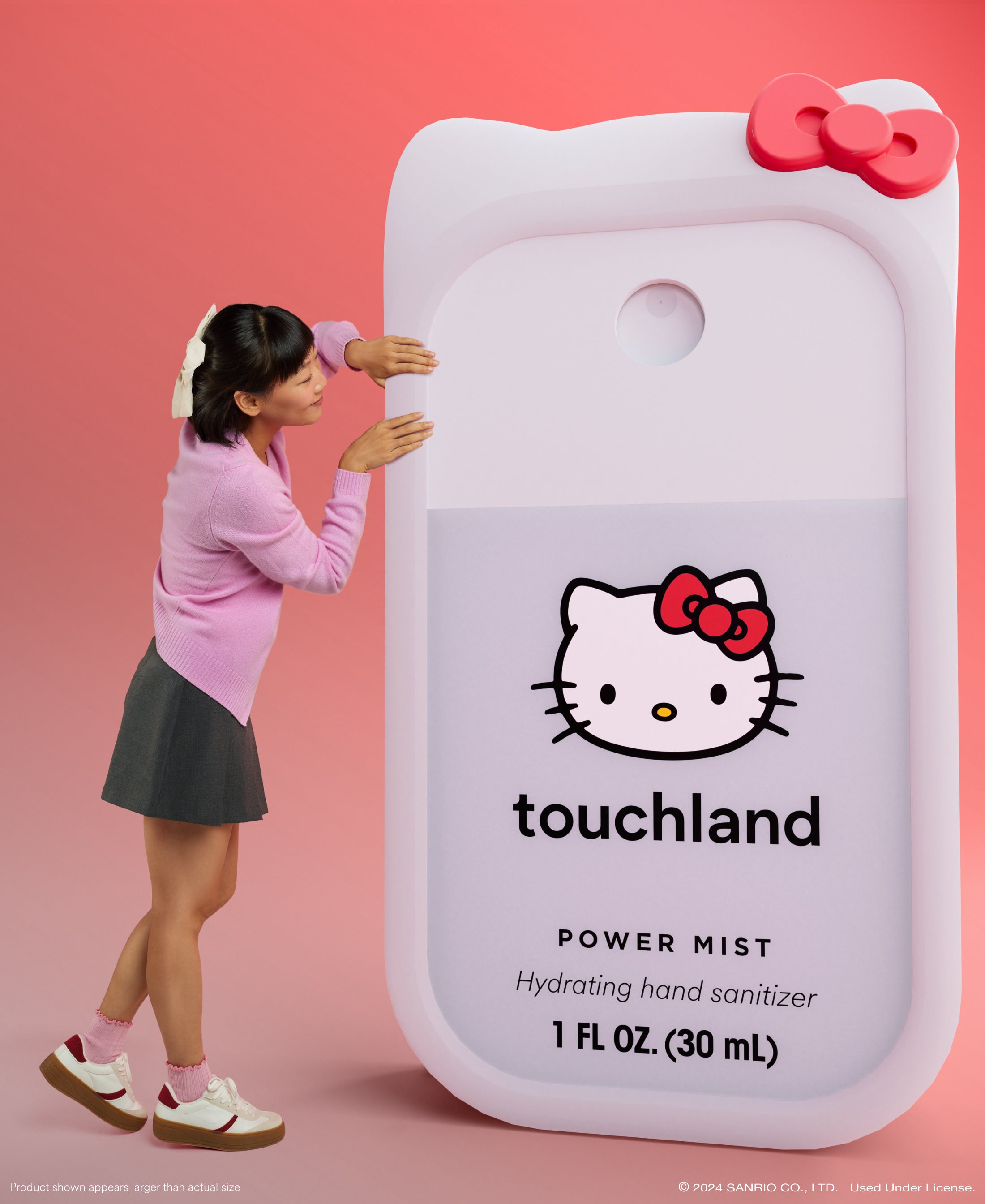 Hello Kitty® Power Mist + Custom Hello Kitty® Mist Case with model. Product shown appears larger than actual size.