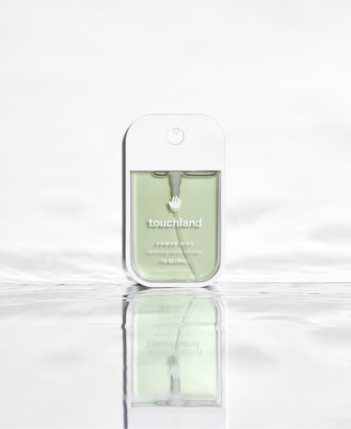 Frontal Power Mist hand sanitizer bottle picture standing on a mirror base with water.