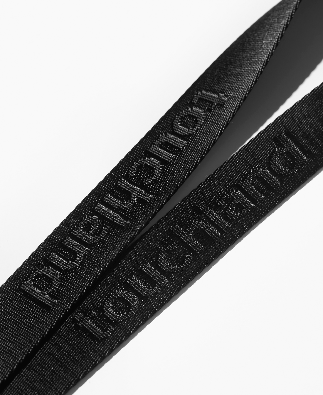 Black lanyard zoomed in on white background