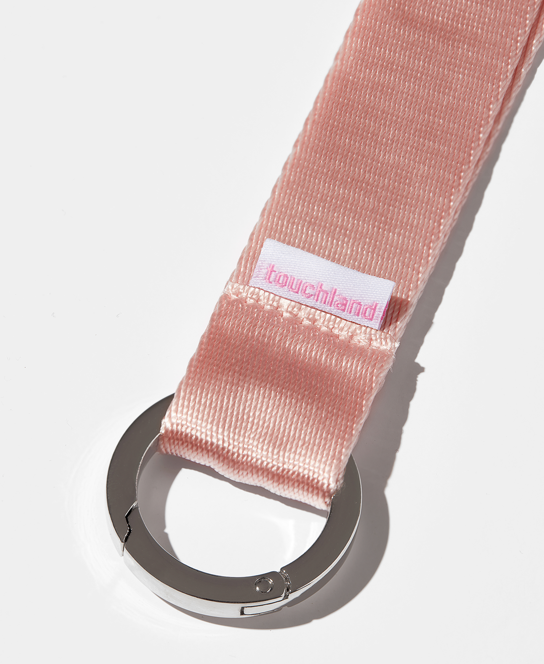 Pink lanyard zoomed in on silver ring 
