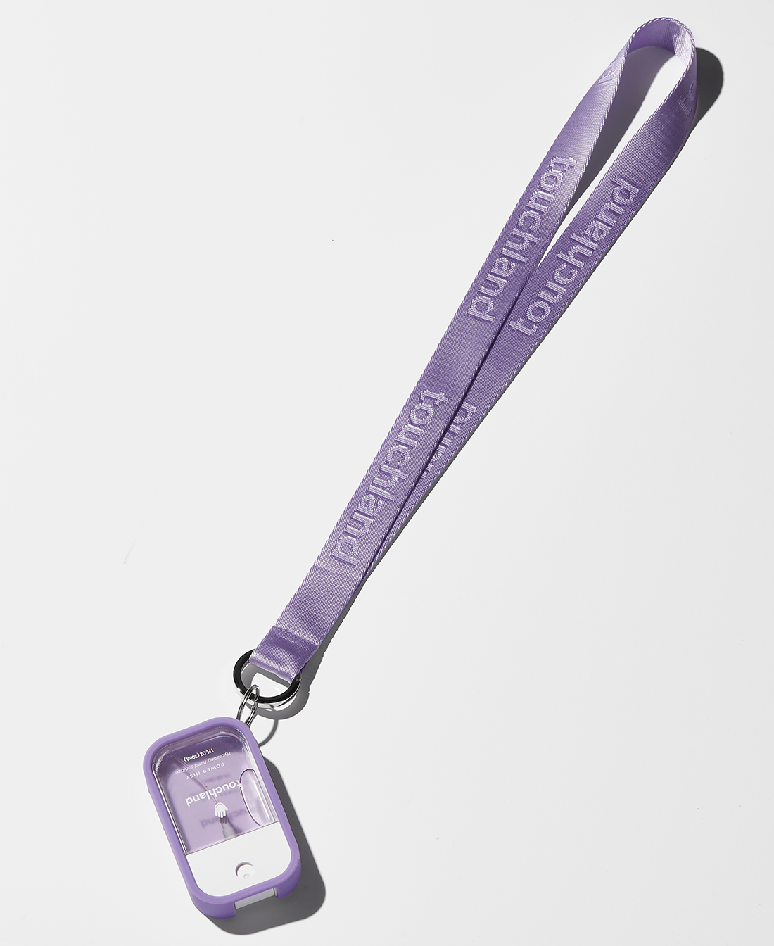 Purple lanyard attached to purple silicone mist case with lavender power mist inside on white background