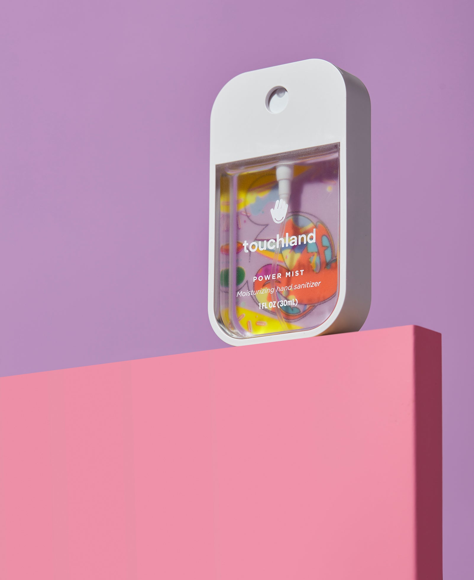 Touchland x disney collection in packaging against purple wall on pink block