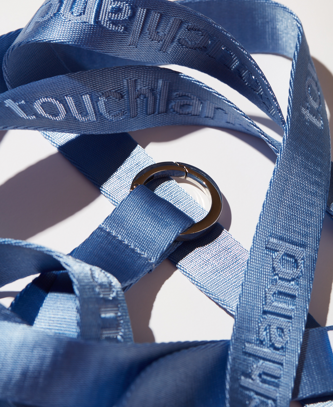 Blue lanyards tangled and zoomed in on white background