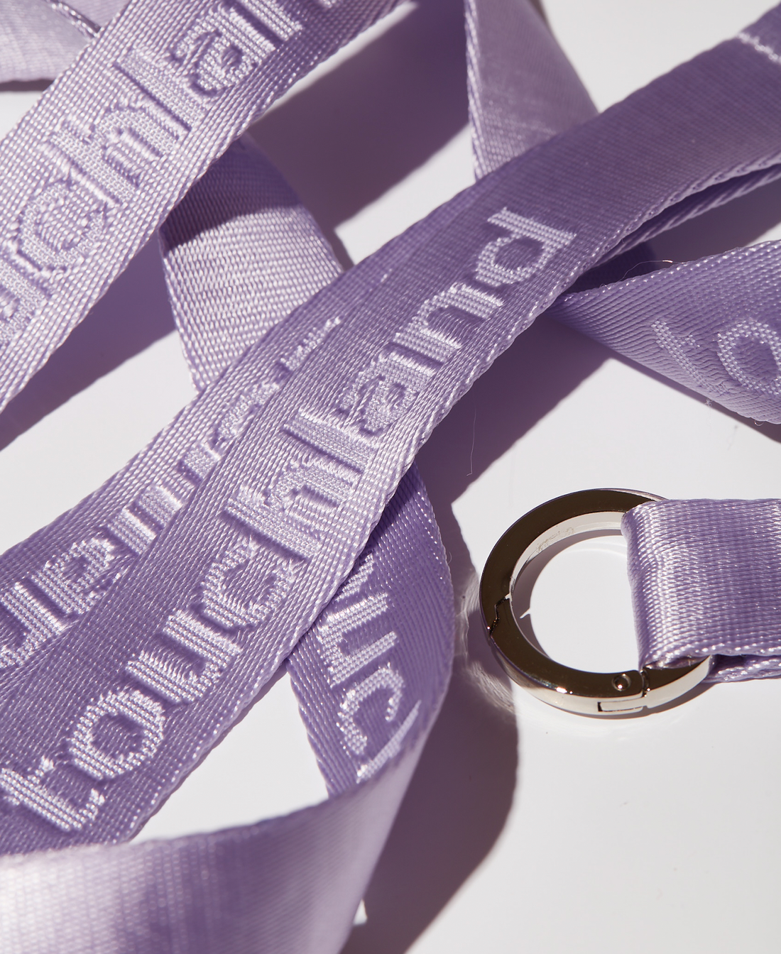 Zoomed in violet lanyards overlapping on white background