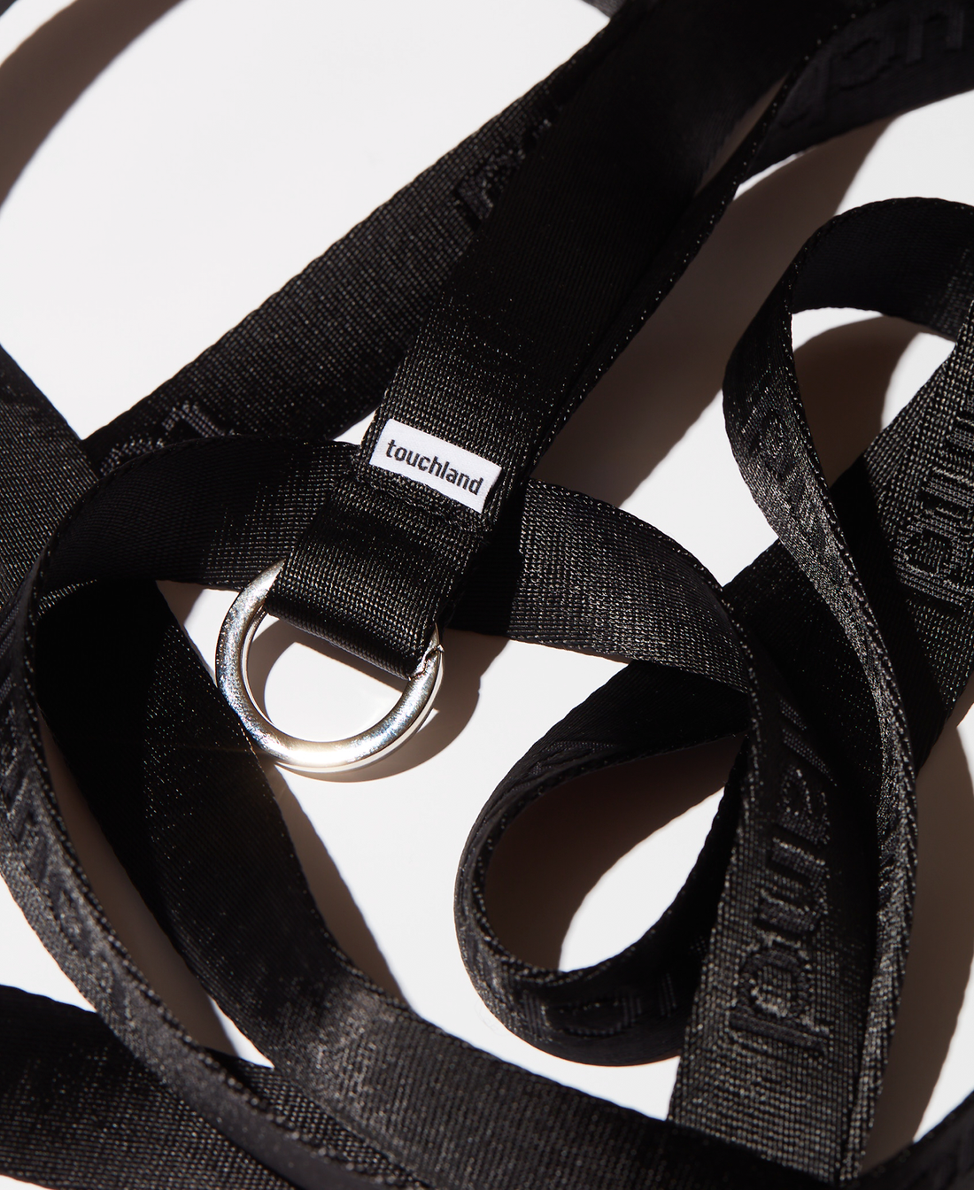 Black tangled lanyard zoomed in on white background