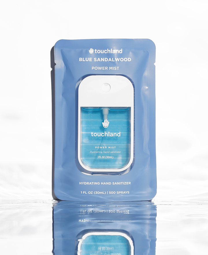 Blue sandalwood power mist hand sanitizer in blue packaging on white background