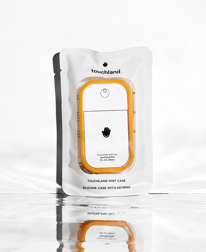 Orange silicone touchland hand sanitizer case with keyring on white background