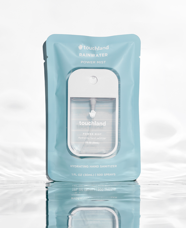 Rainwater power mist grey hand sanitizer in blue packaging on white background