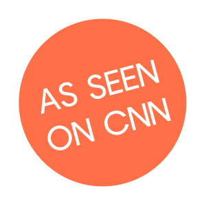 Peach circle with thite text that reads "AS SEEN ON CNN"